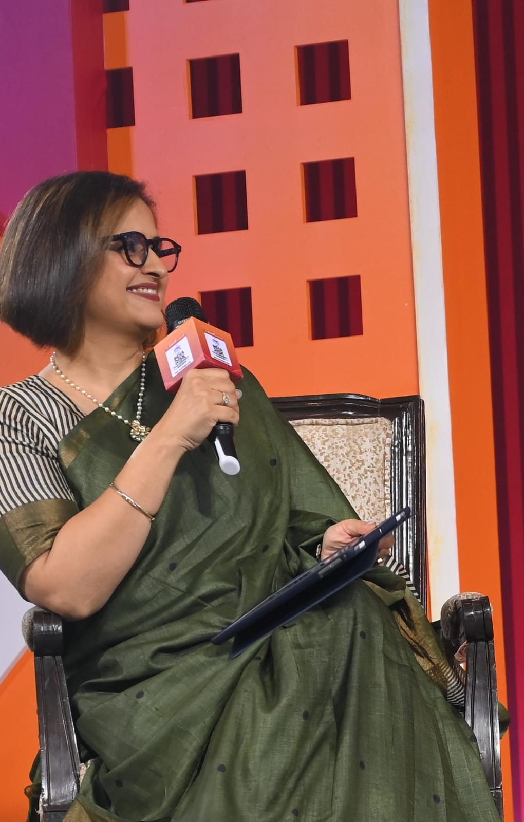 Mugdha Kalra speaking on stage